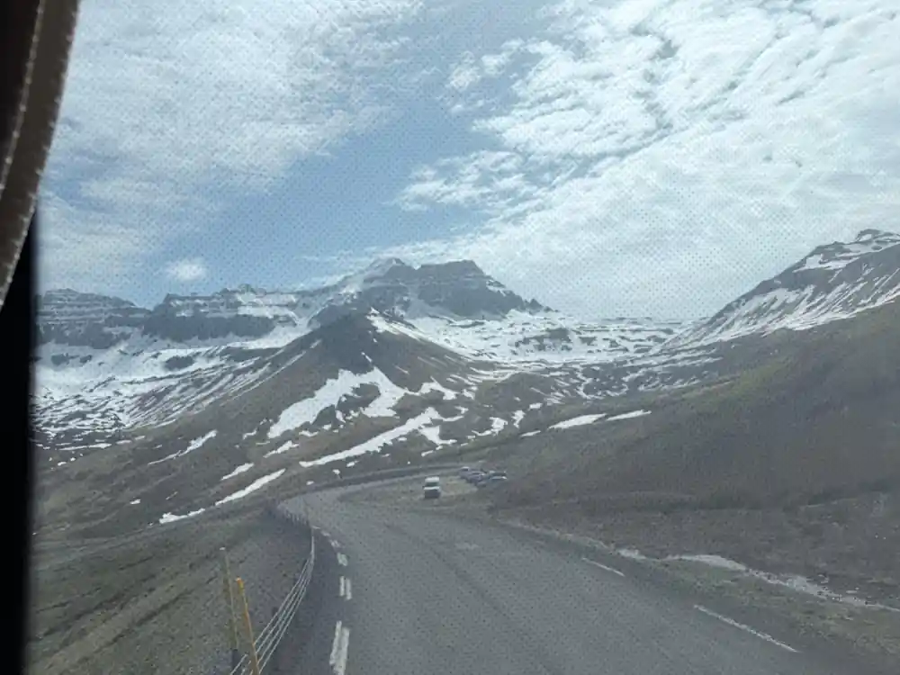 Mountain road winding through snowy volcanic landscape
