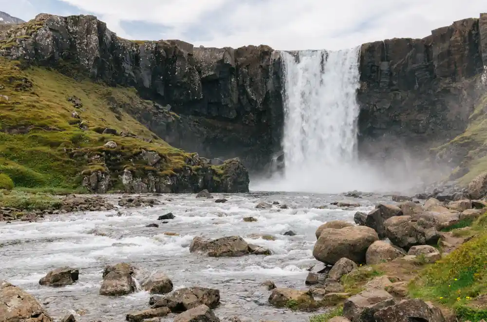 Powerful waterfall cascading over dark rocky cliff