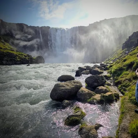 A waterfall tumbling past moss-covered rocks